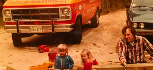 From the Robies archives: Gerry Robichaud with the children in front of an old Robies service vehicle