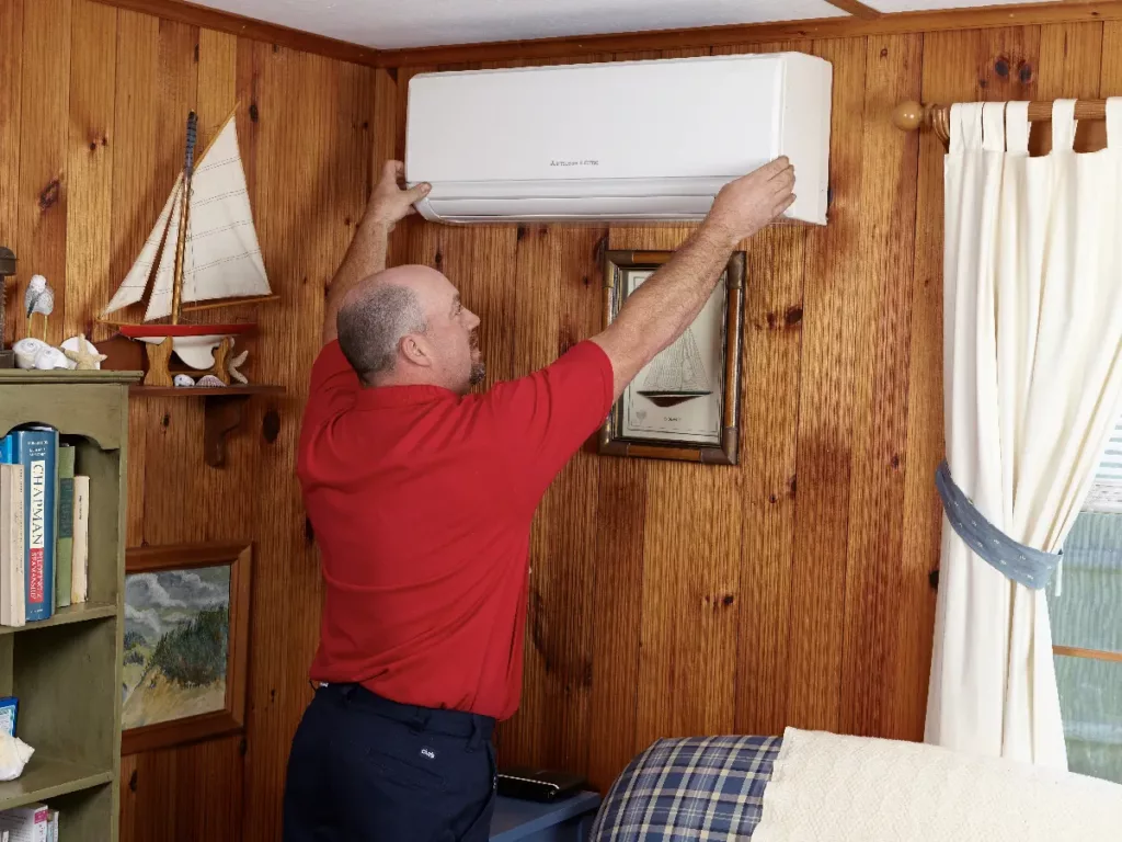 Robies employee fixing a ductless unit