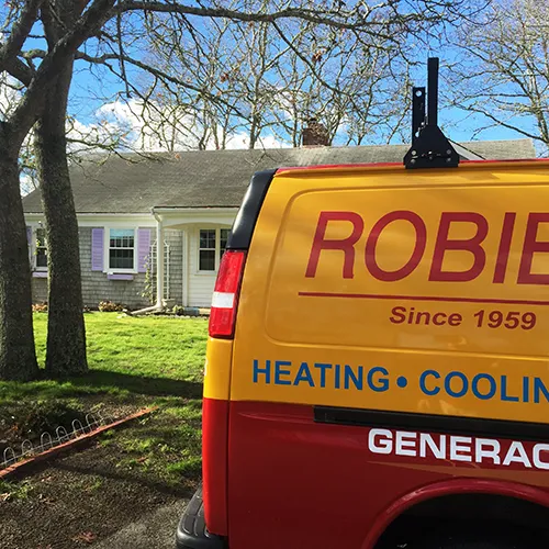 A Robies work van during heating system maintenance at a home on Cape Cod