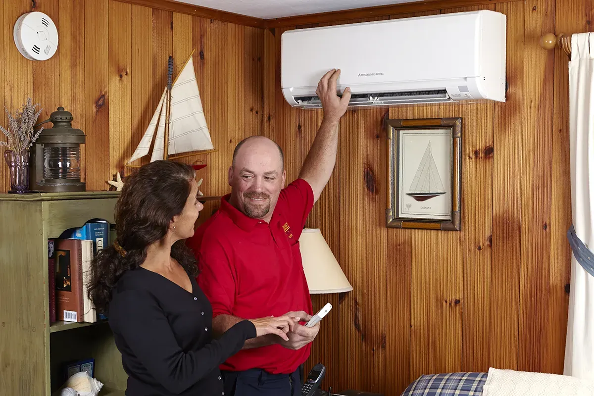 Robies employee explaining a ductless unit to a customer
