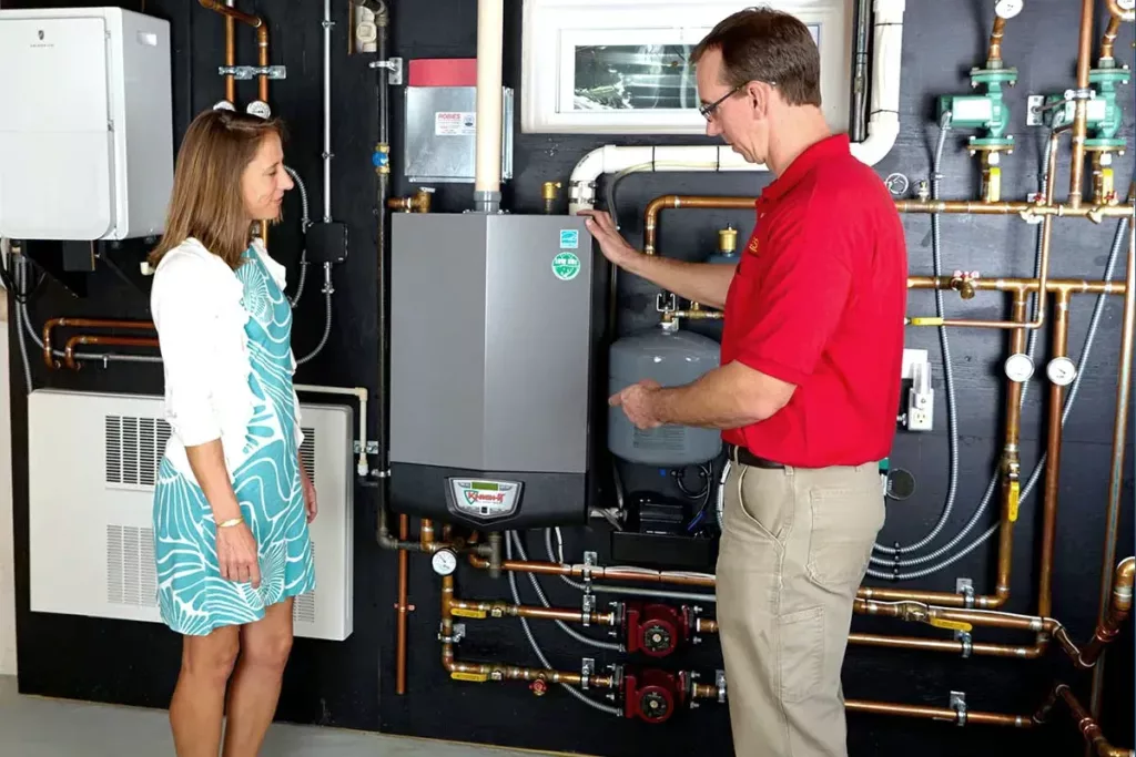 Robies employee explaining a boiler to a customer