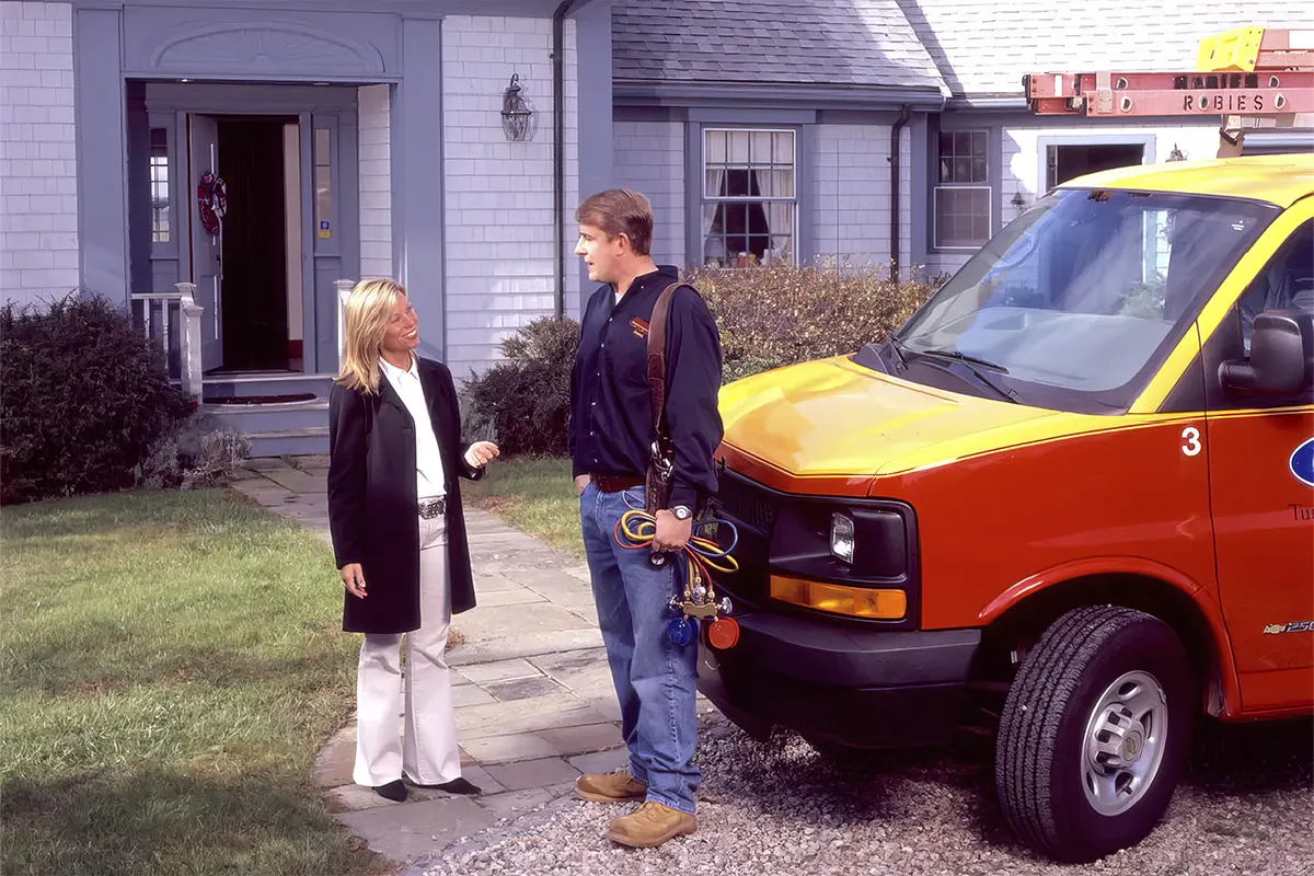 A Robies employee visiting a customer for maintenance work on their home system